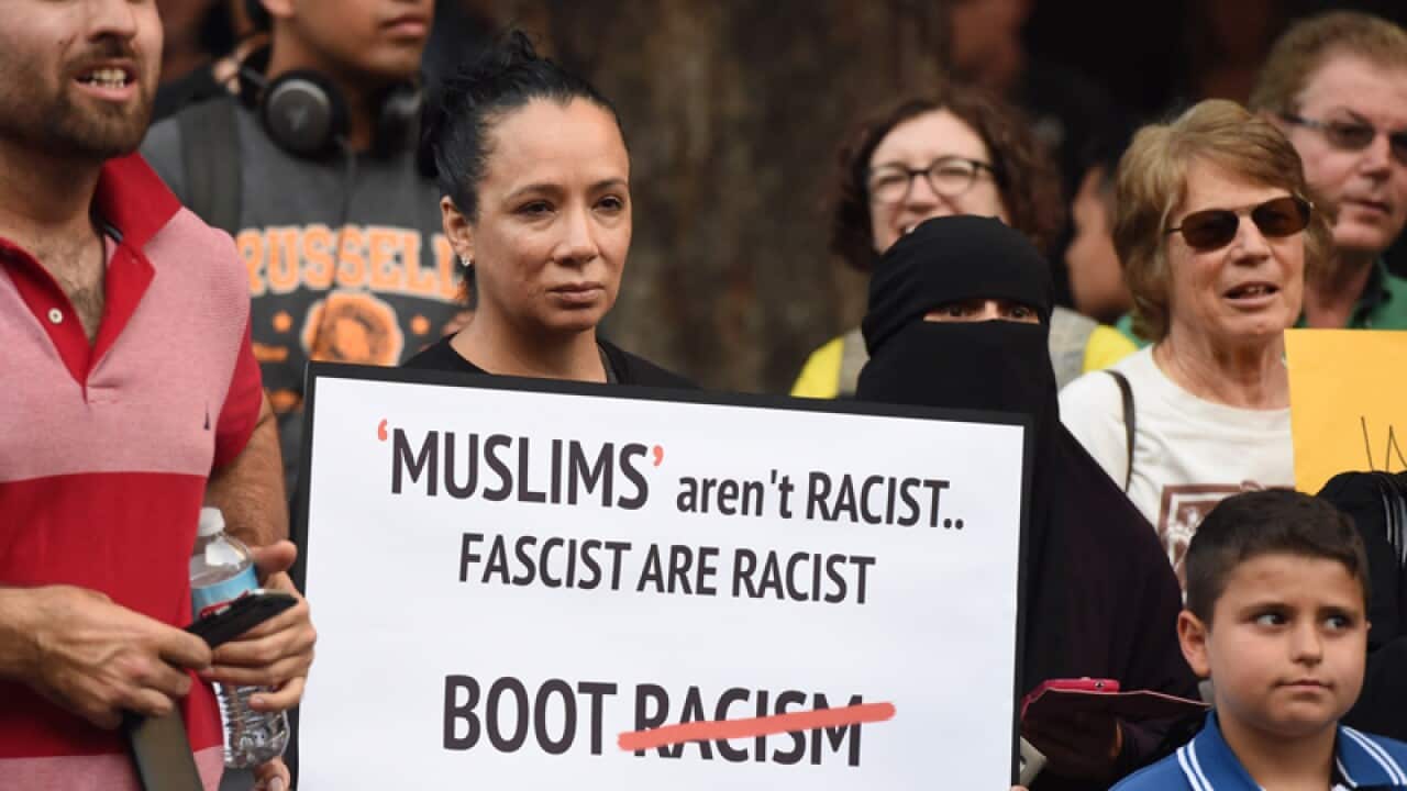 Anti-racism protesters are seen at a rally