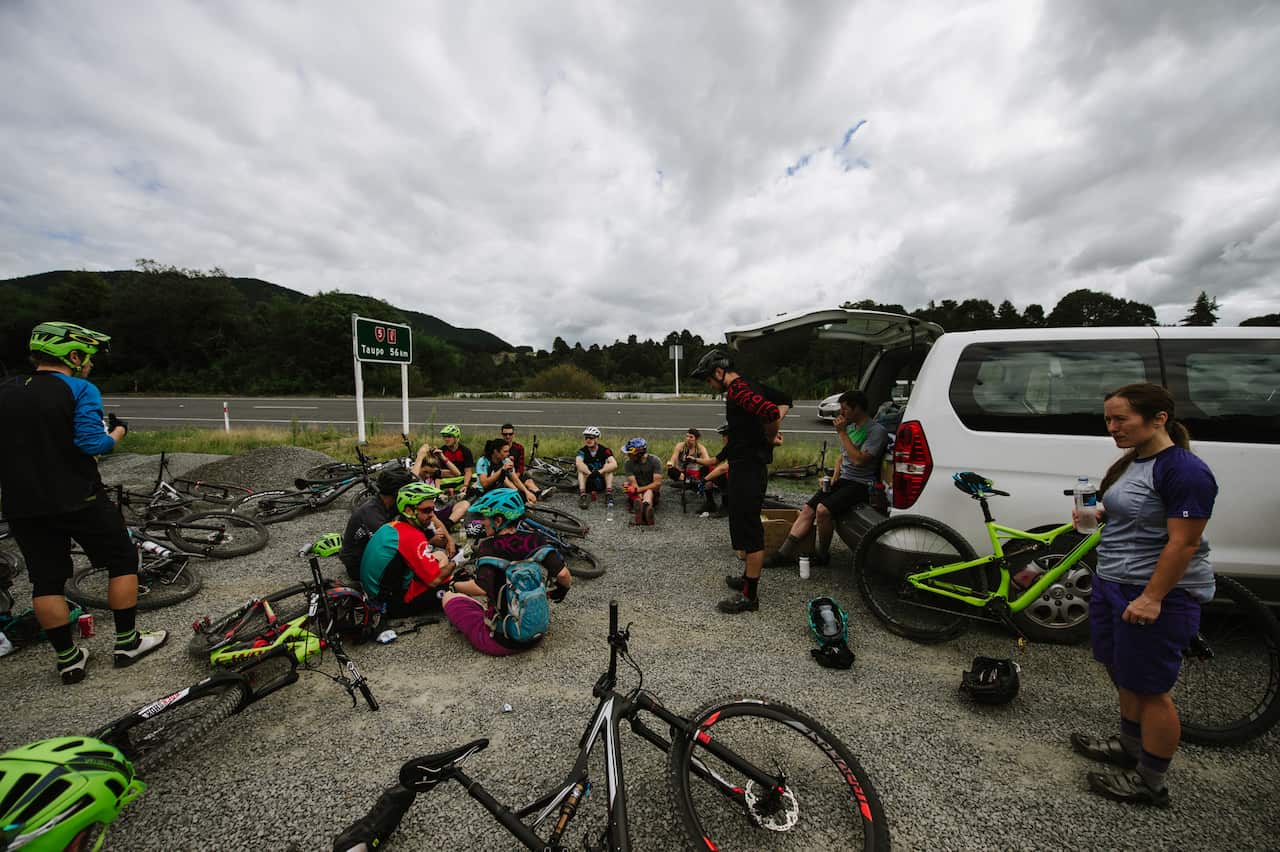 Riders sit in a carpark to eat launch