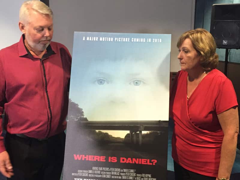 Bruce and Denise Morcombe pose with a promotional film poster.