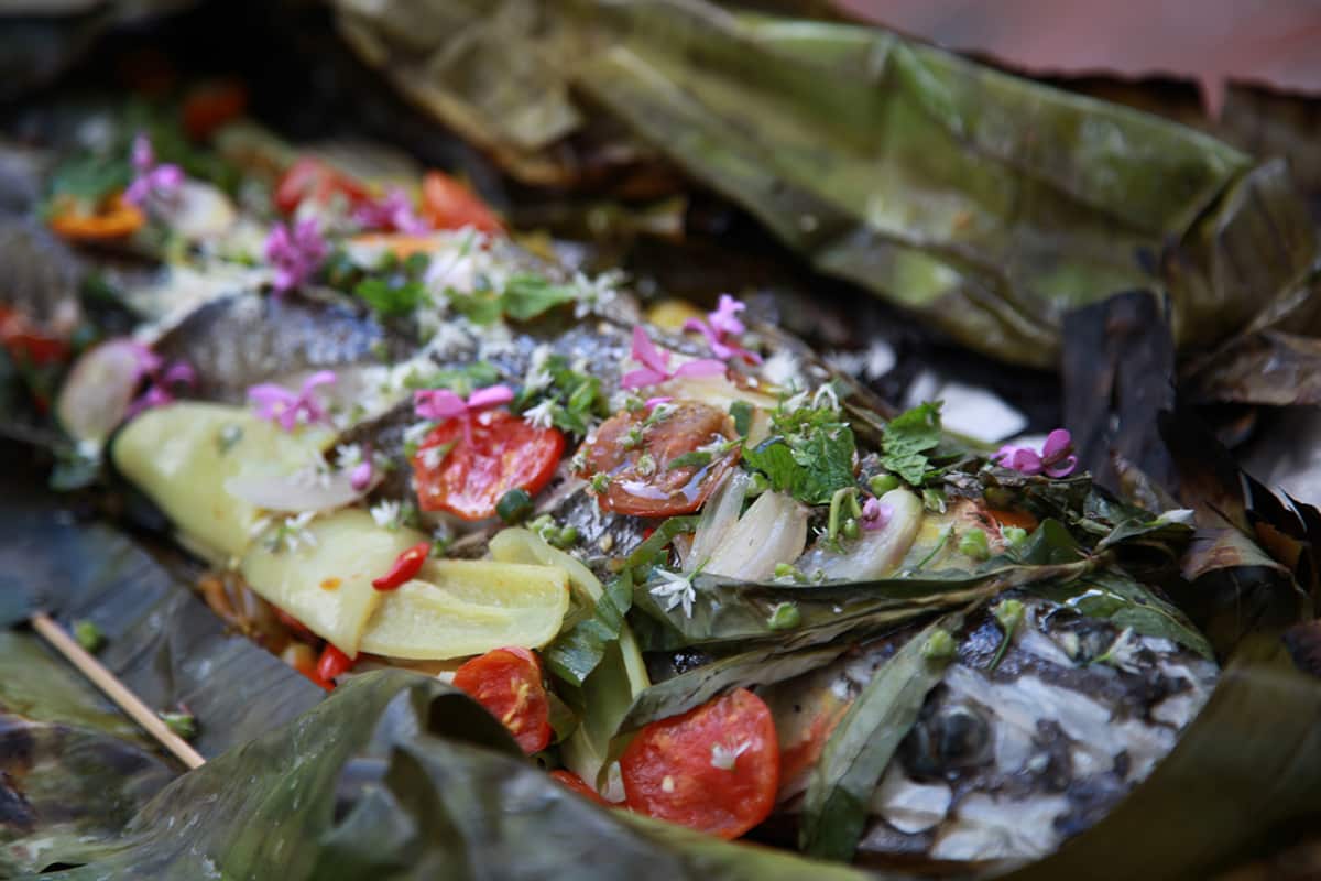 Grilled whole flathead in banana leaf