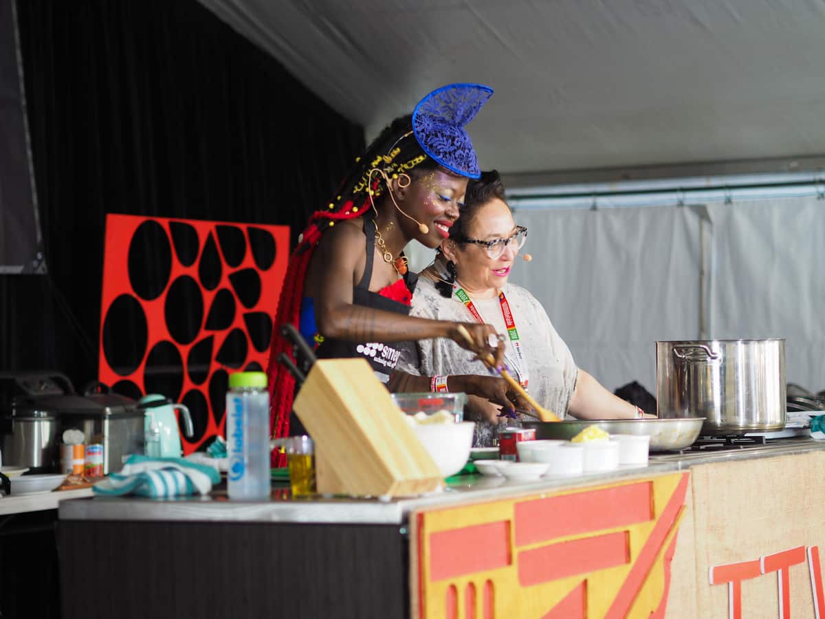 Rosa Matto (right) learns more about artist Jojo Abot and the food she loves at WOMADelaide.