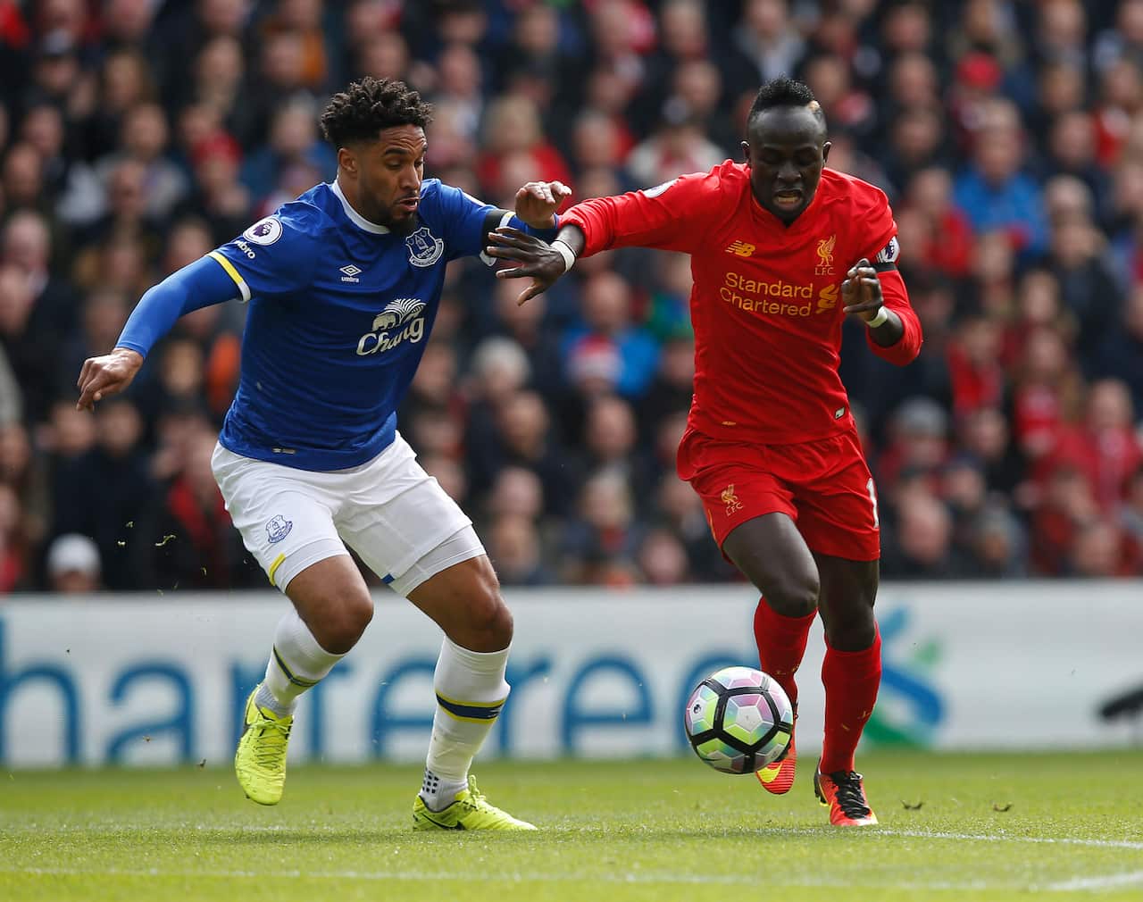Ashley Williams of Everton in action with Sadio Mane of Liverpool during the English Premier League match at Anfield Stadium, Liverpool.
