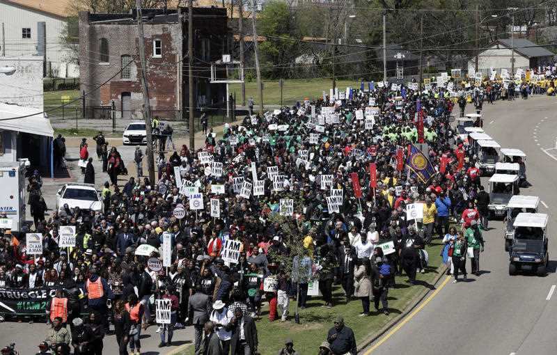 People take part in a march commemorating the anniversary of the assassination of Rev. Martin Luther King Jr. Wednesday, April 4, 2018