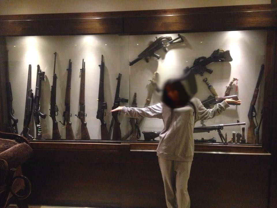 A model poses with guns