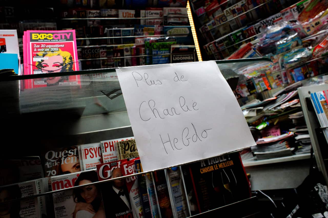 A paper that reads: "No more Charlie Hebdo" is posted after all copies of the satirical newspaper were sold out at a newsstand in Paris. (AP Photo/Christophe Ena)