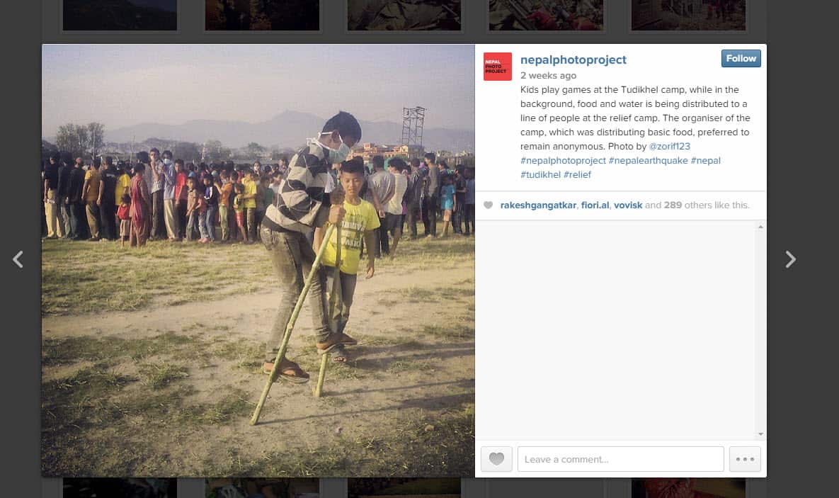 Kids play games at the Tudikhel camp, while in the background, food and water is being distributed to a line of people at the relief camp. Photo by @zorif123 Nepal Photo Project