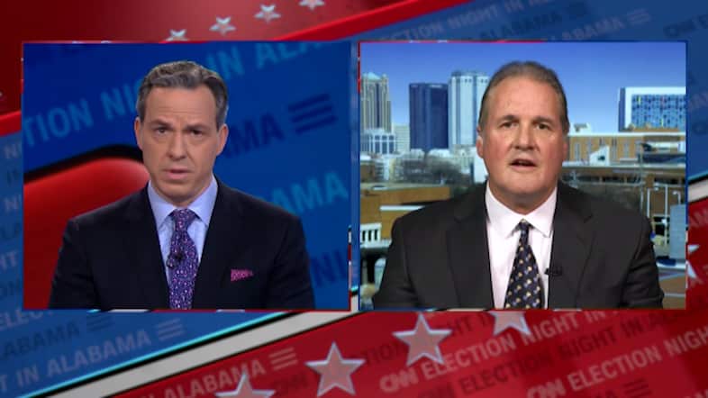 Jake Tapper (pictured left) corrected Ted Crockett (pictured right) to leave him speechless.