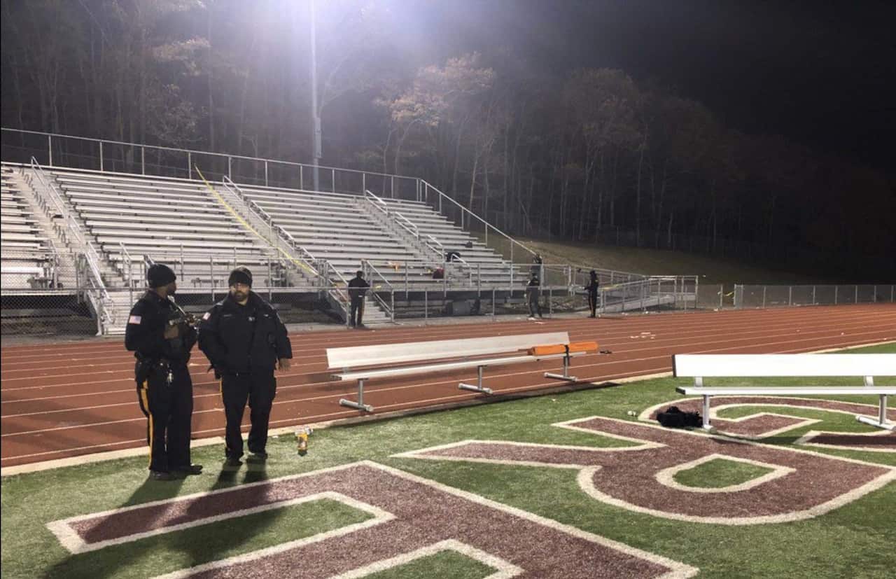The police searching the bleachers after gunshots were fired at a high school football game outside of Atlantic City.