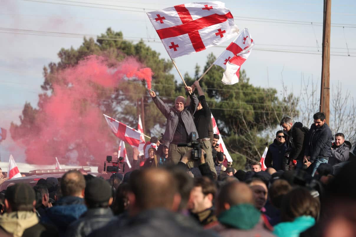Supporters of former Georgian opposition presidential candidate Grigol Vashadze clash with police officers during a protest rally