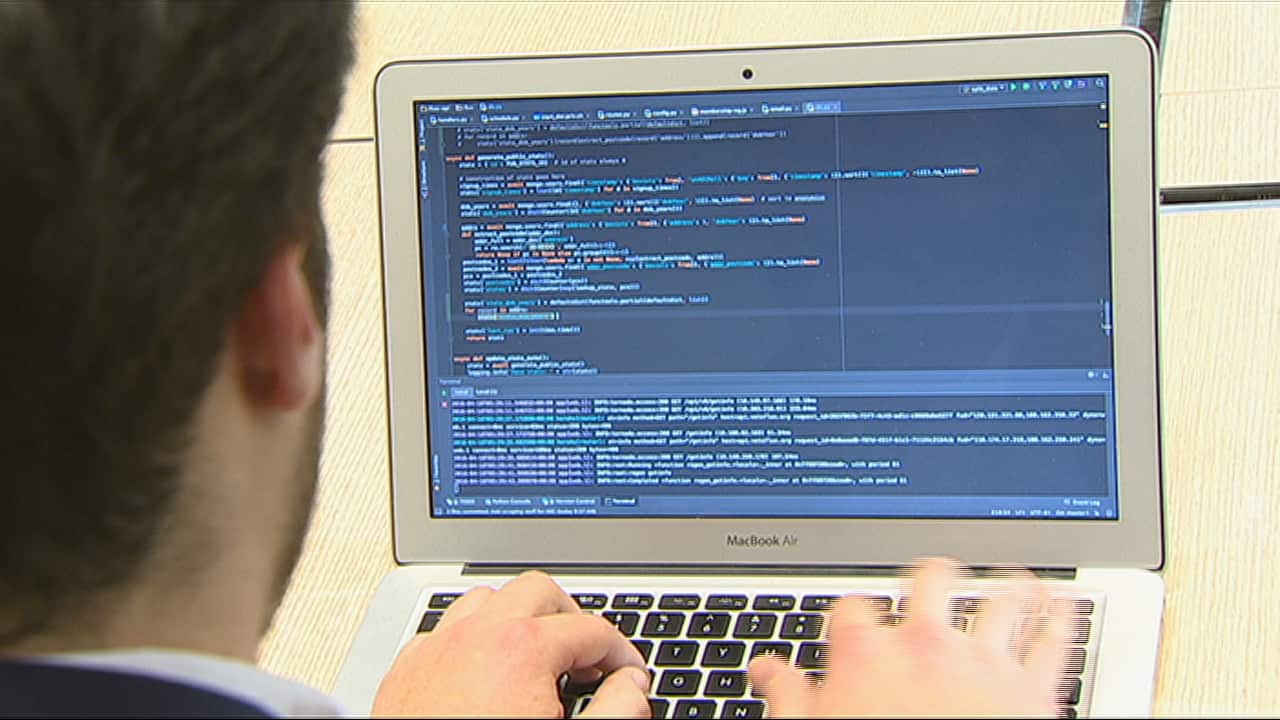 Flux co-founder Max Kaye works on some code for the party's app. 