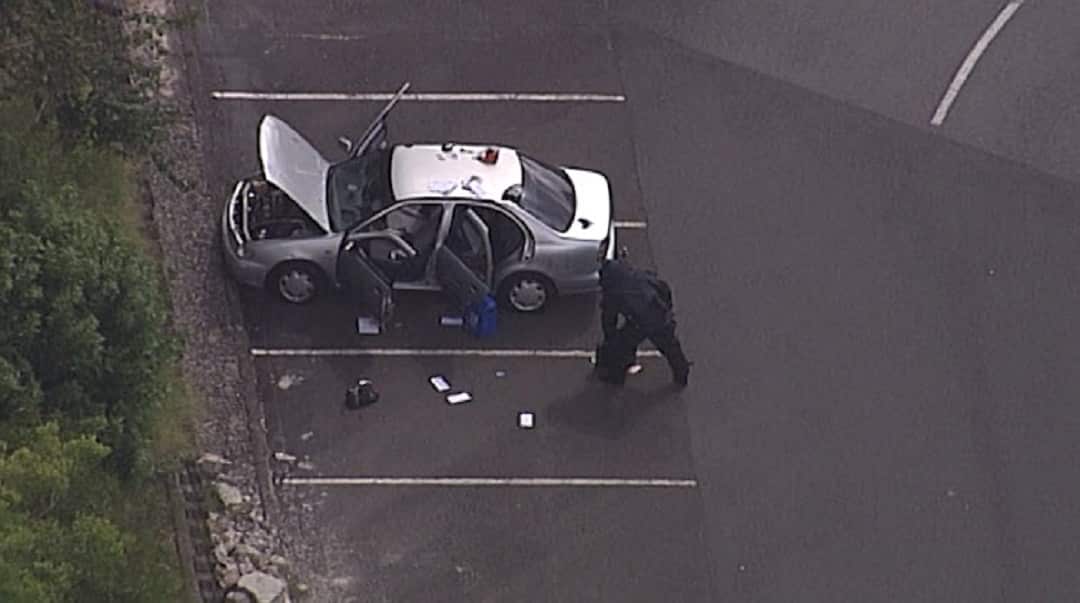 Bomb squad officers inspecting the vehicle.