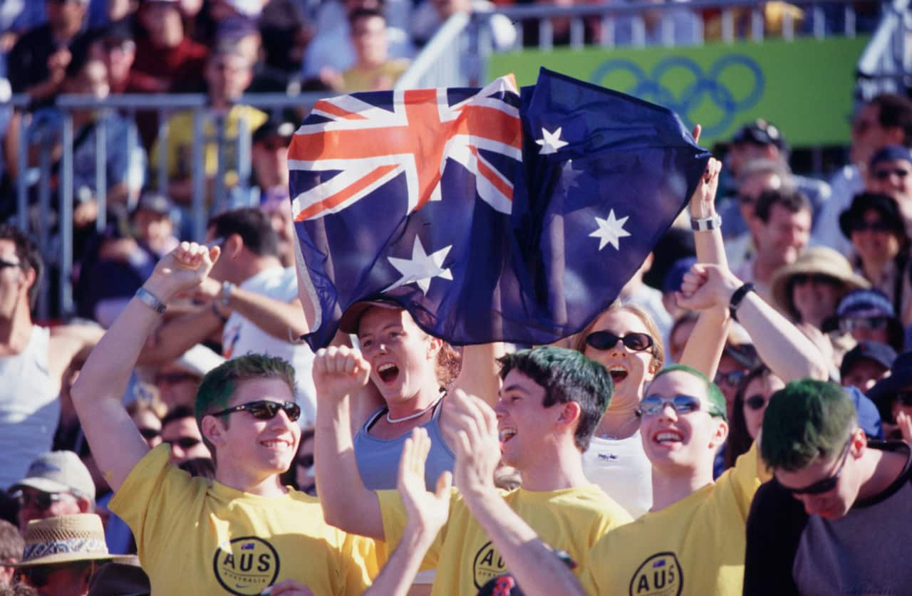 OLY610 SYDNEY, Aus - Australian sports fans show the flag at he Sydney Olympic Games 2000. (AAPIMAGE/DL)