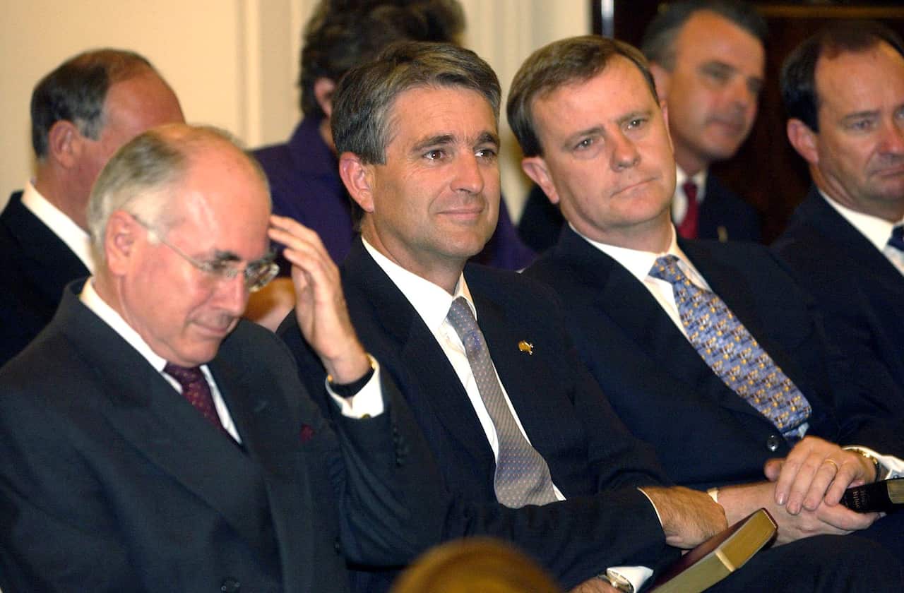 PM John Howard,Deputy PM John Anderson & Treasurer Peter Costello during the Swearing-In ceremony of Ministers at Government House Canberra today. (AAP Image/Alan Porritt) NO ARCHIVING