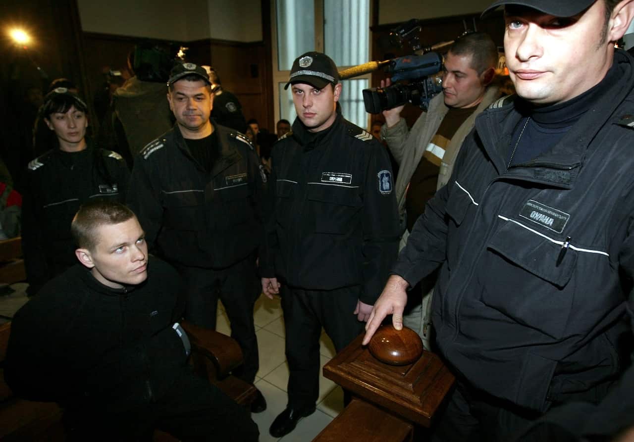 Bulgarian policemen stand guard around Australian Jock Palfreeman.