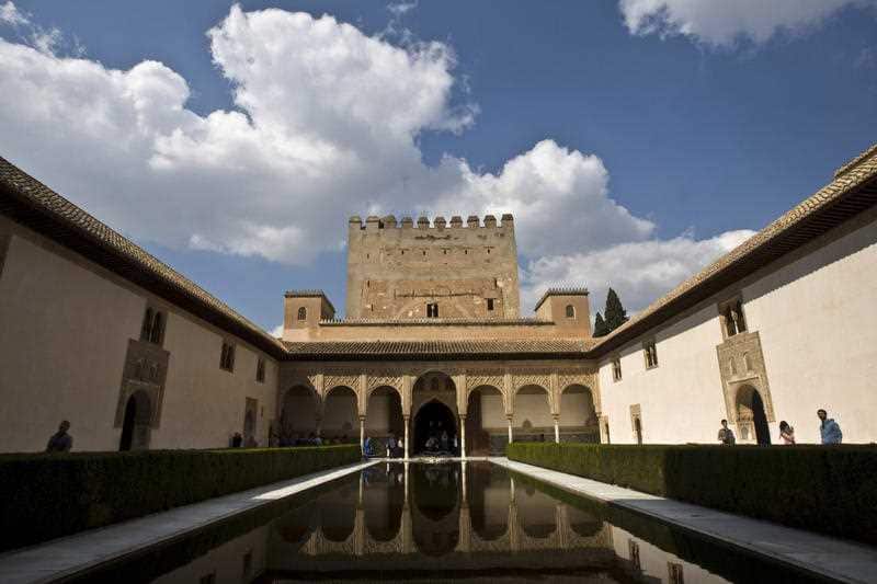 tourists visit the the Comares Palace at the Alhambra in Granada, Spain. Granada is home to one of Spain's most visited tourist sites, the masterpiece of Islamic architecture known as Alhambra, a Middle Ages palace.