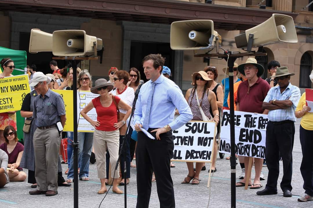Benedict Coyne speaks to protesters at a rally against the Australian government's asylum seekers policy in 2014.