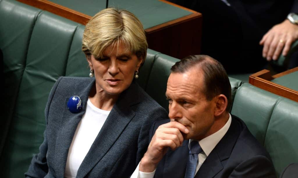 Prime minister Tony Abbott and foreign minister Julie Bishop listen as Opposition leader Bill Shorten delivers his budget reply speech to the House of Representatives at Parliament House in Canberra, Thursday, May 15, 2014. (AAP)