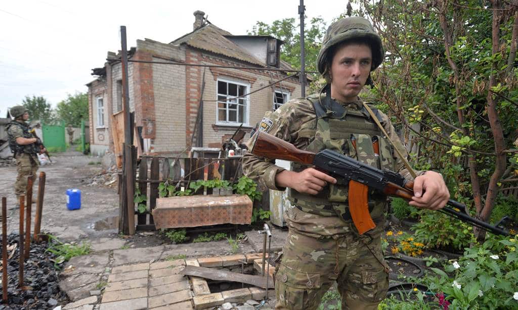 A Ukrainian serviceman patrols in the village of Semenovka, near the eastern Ukrainian city of Slavyansk in the Donetsk region on July 14, 2014. (AFP)