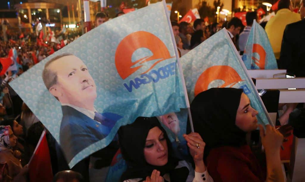 Supporters of newly elected Turkish president Recep Tayyip Erdogan listen to his speech from the balcony of the AKP party headquarters during the celebrations of his victory in the presidential election vote in Ankara on August 10, 2014. (AFP)