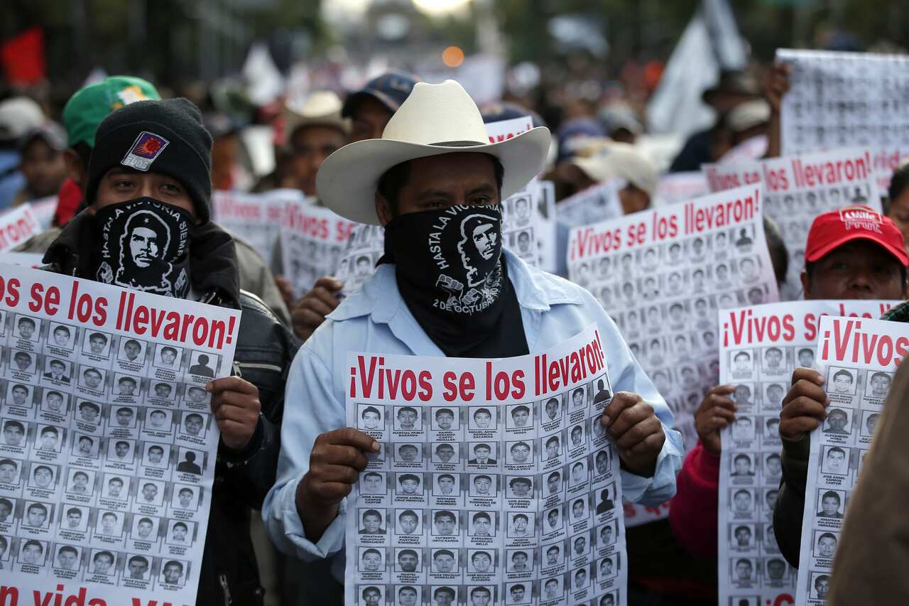 Protesting the disappearance of 43  Mexican students. The signs read "They took them alive".