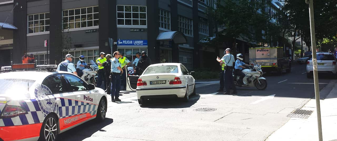 Police inspect a vehicle involved in a car chase through the Sydney CBD on Saturday. (AAP)