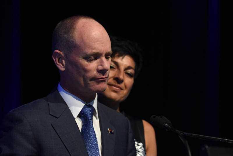 Queensland Premier Campbell Newman, flanked by his wife Lisa, concedes defeat in the state election in Brisbane.