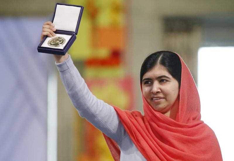 Malala Yousafzai displaying her medal during the award ceremony of the 2014 Nobel Peace Prize at Oslo City Hall, Norway, 10 December 2014.