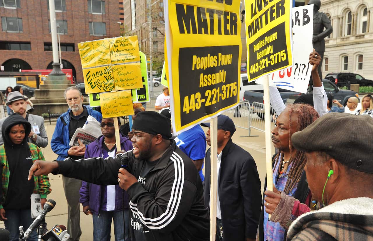 Rev. Cortly "C.D." Witherspoon, front left, speaks at a protest outside City Hall about Freddie Gray in Baltimore, April 20, 2015. (Amy Davis/The Baltimore Sun via AP)