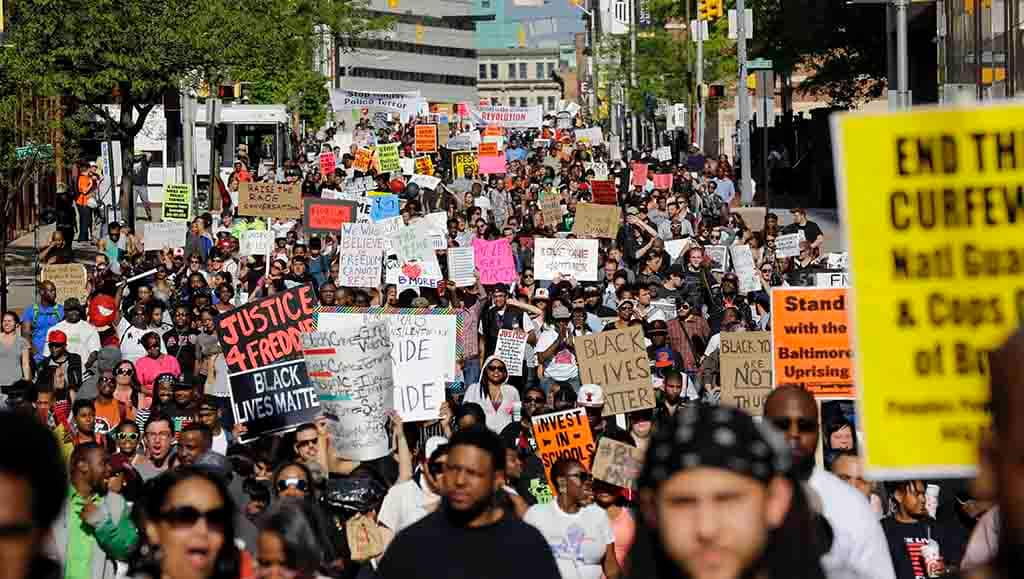 Protesters march through Baltimore on Saturday, May 2, 2015, the day after charges were announced against the police officers involved in Freddie Gray's death. (AP Photo/Patrick Semansky)