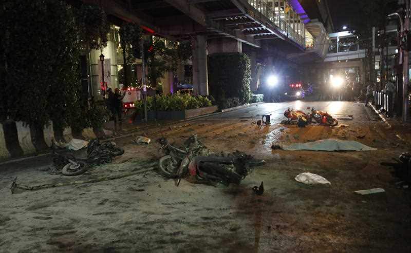 Motorcycles and debris are strewn across Rajprasong Intersection in front of the Erawan Shrine after an explosion in Bangkok, Monday, Aug. 17, 2015. (AAP)