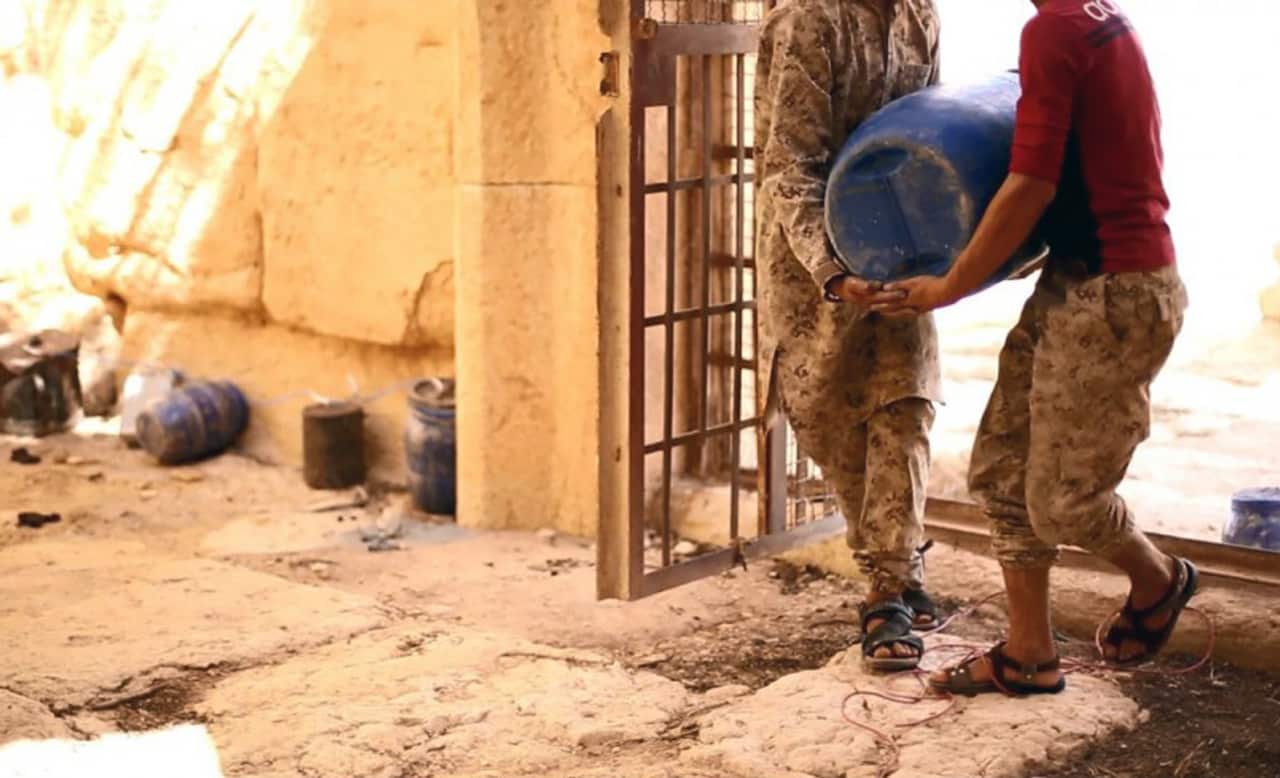 This undated file photo shows shows militants laying explosives in the 2,000-year-old temple of Baalshamin in Syria's ancient caravan city of Palmyra. (Islamic State social media account via AP)