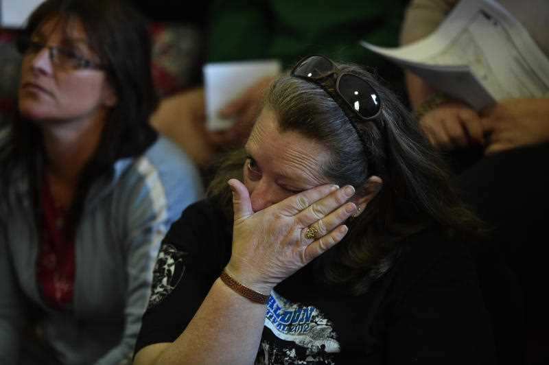 A resident in the fire zone become emotional during a town meeting at the Lancefield Mechanics Institute north of Melbourne, Wednesday, Oct. 7, 2015. Unseasonal hot temperature and winds yesterday sparked dozens of bushfires across Victoria. (AAP Image/Ju