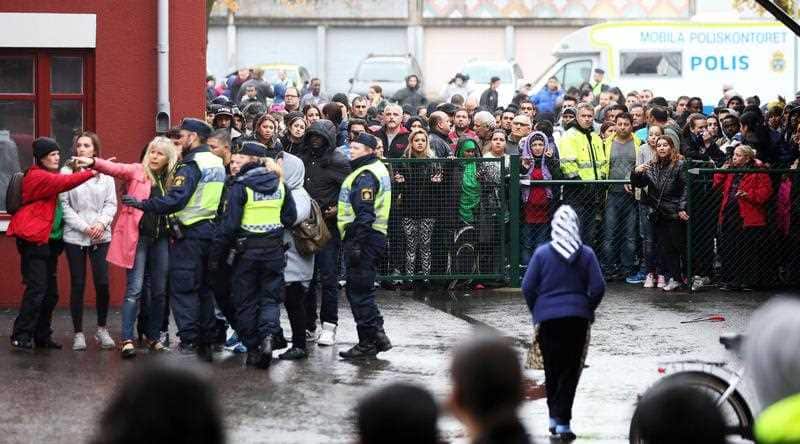 A crowd gathers near the scene of a sword attack by a masked man at the Kronan school in Trollhattan, Sweden, Thursday Oct. 22, 2015. (Bjorn Larsson Rosvall / TT via AP)