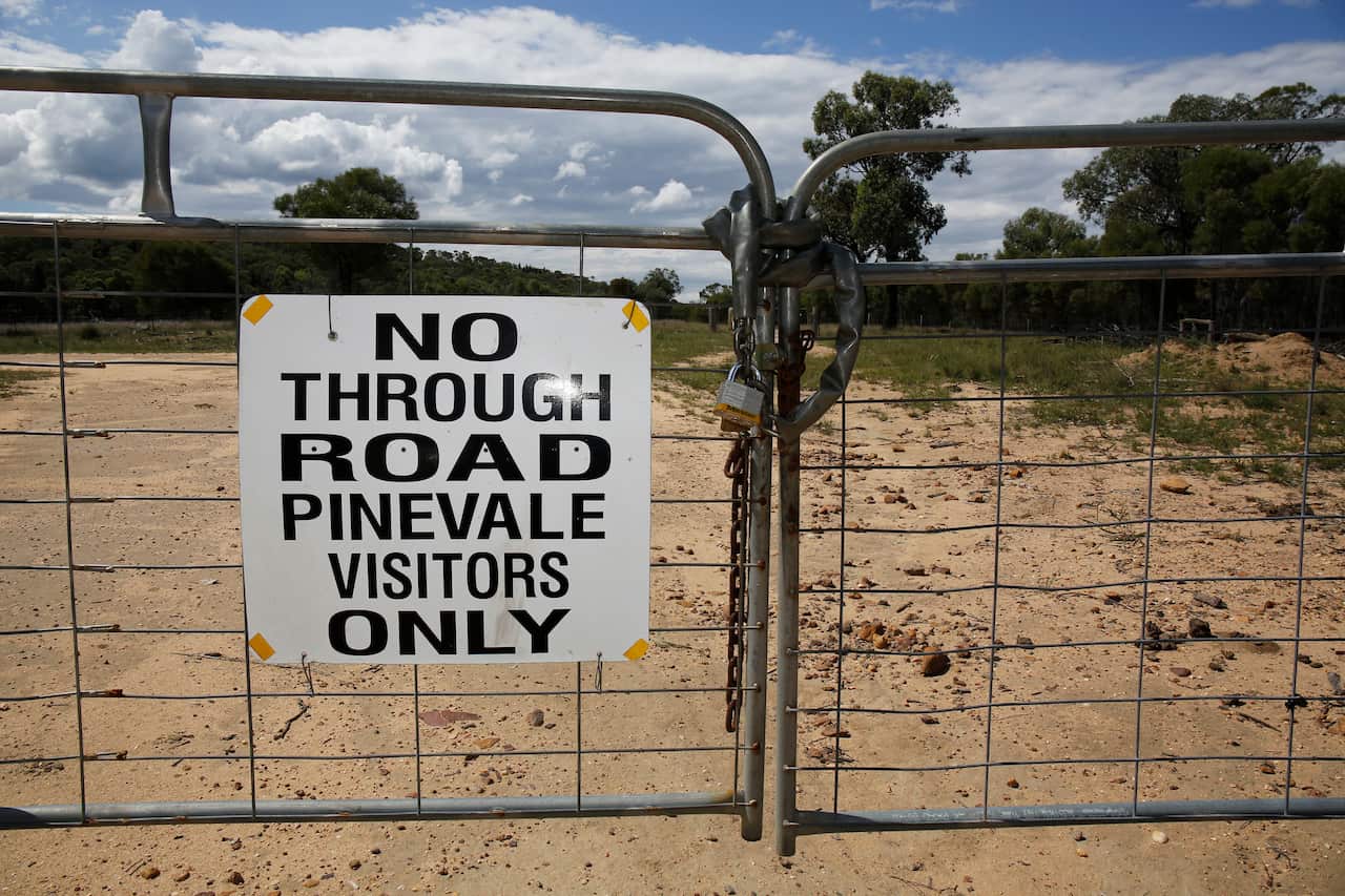 A locked gate on a road to Pinevale farm