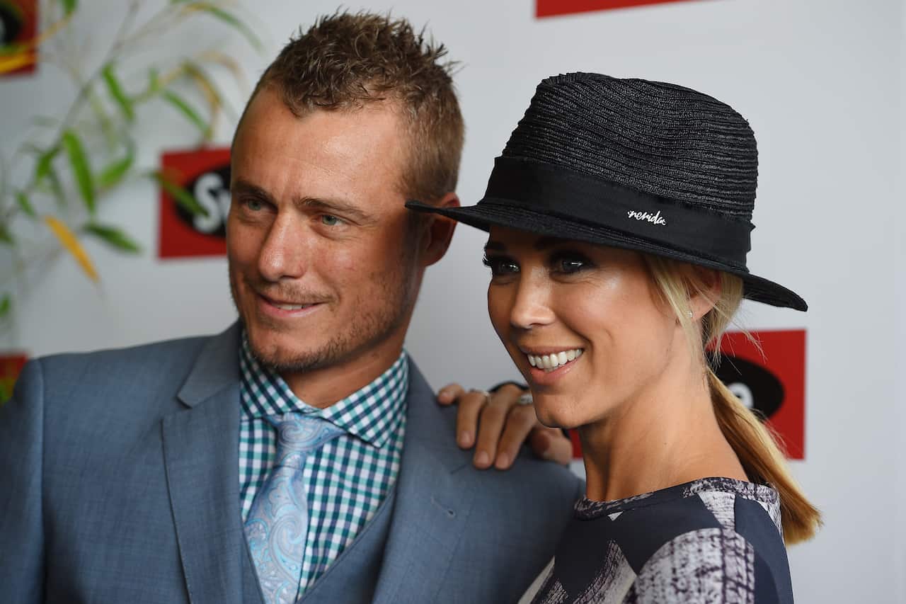 Lleyton and Bec Hewitt pose for photographs in the Swisse marquee at the Birdcage on Melbourne Cup Day at Flemington Racecourse, in Melbourne, Tuesday, Nov. 3, 2015. (AAP Image/Dan Himbrechts) NO ARCHIVING, EDITORIAL USE ONLY
