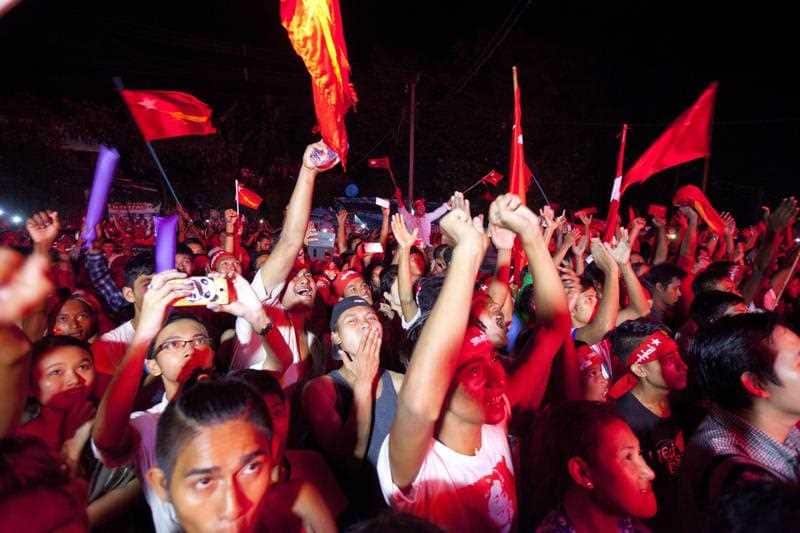 Supporters of Myanmar opposition leader Aung San Suu Kyi’s National League for Democracy party cheer as they watch the results of the general election on an LED screen displayed outside the party’s headquarters.
