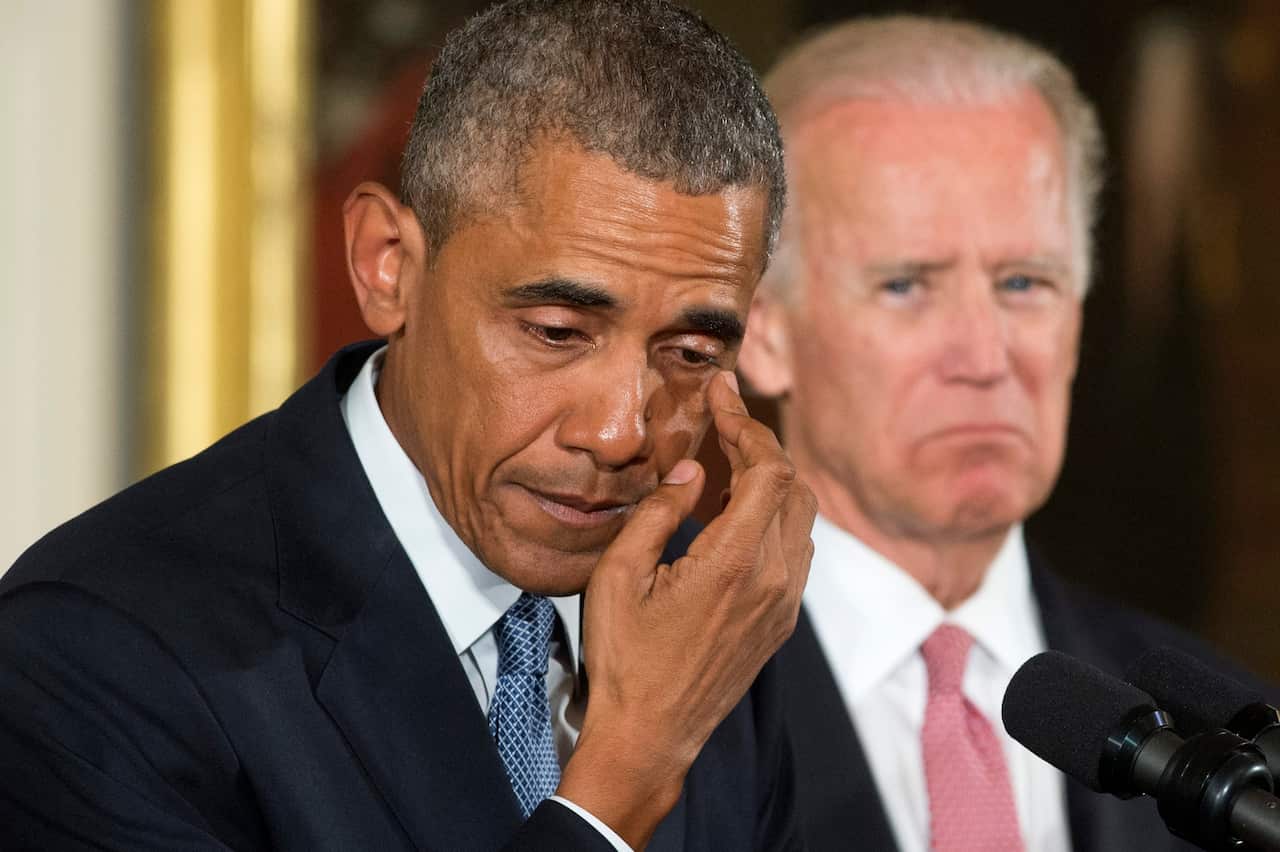 US President Barack Obama (L) wipes away tears while delivering remarks at an event held to announce executive actions to reduce gun violence.