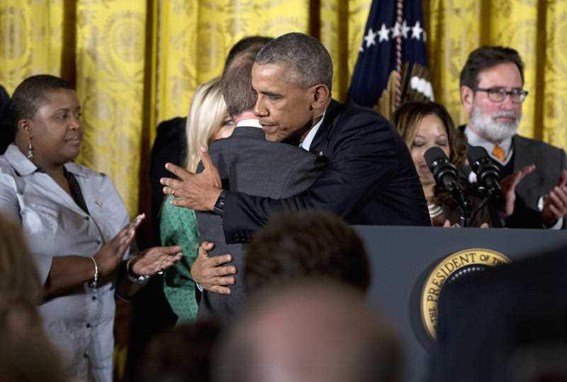 President Barack Obama embraces Mark Barden, whose son Daniel died in the Sandy Hook shooting, as he arrives to speaks in the East Room of the White House in Washington, Tuesday, Jan. 5, 2016