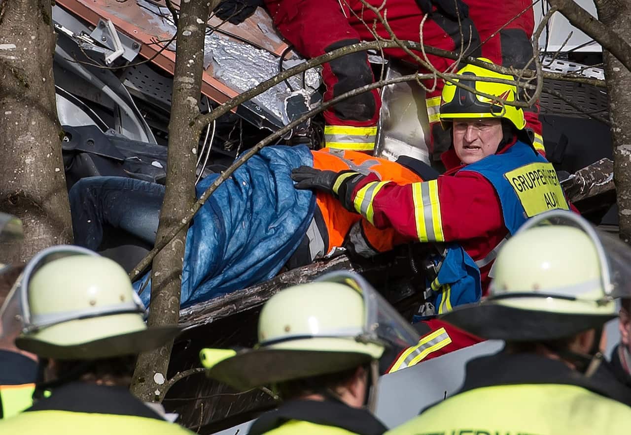 Members of the emergency services recover a victim from the scene of a train accident near Bad Aibling, Germany, 09 February 2016. 
