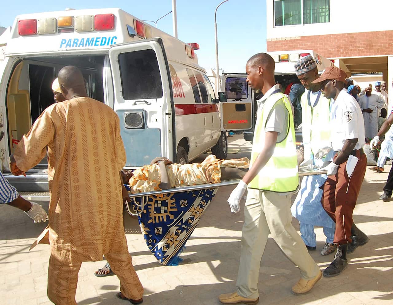 Rescue workers transport a victim of a suicide bomb attack at a refugee for treatment at a hospital, in  Maiduguri, Nigeria, Wednesday, Feb. 10, 2016.