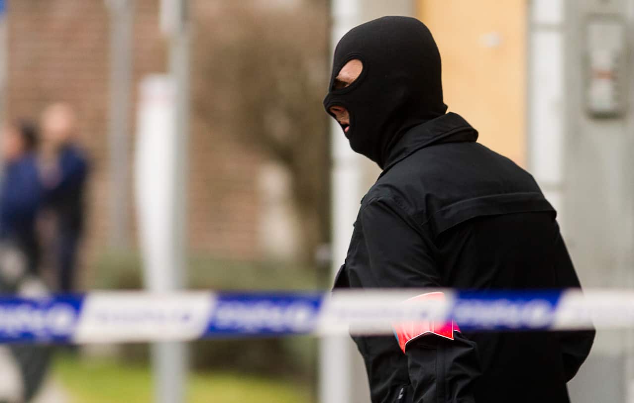 Police secure an area after an apartment raid in Brussels on Tuesday March 15, 2016. 
