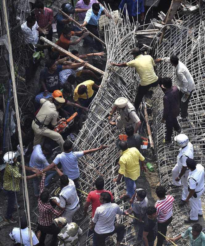 Locals and rescue workers look for survivors under the rubbles of a partially collapsed overpass in Kolkata, India, Thursday, March 31, 2016.