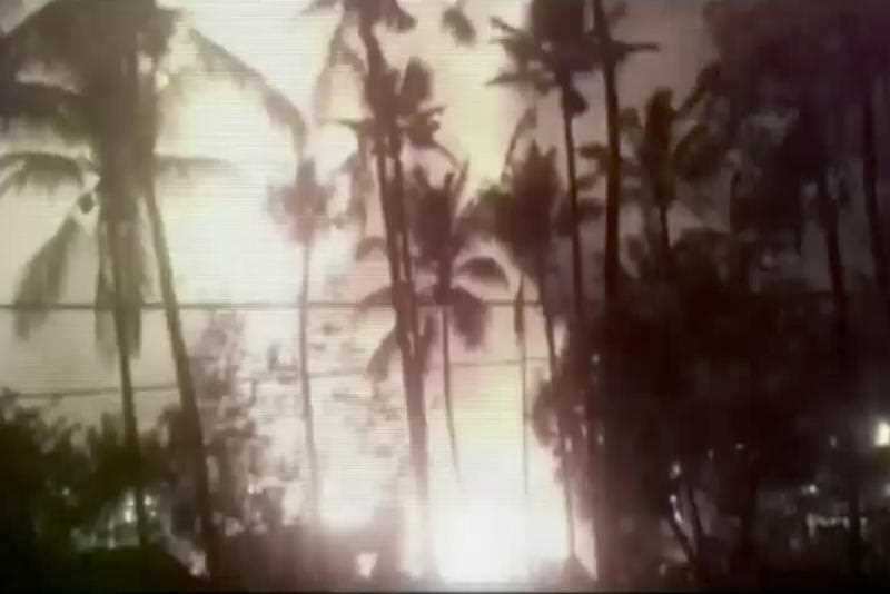 In this image made from video, a flash from an explosion is seen from the ground during a fireworks show at a temple in Kollam