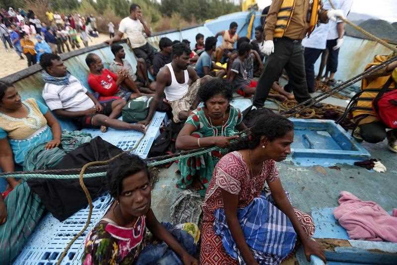 Srilankan migrant get medical checks while their migrant boat is stranded at Lhoknga Beach, Aceh, Indonesia