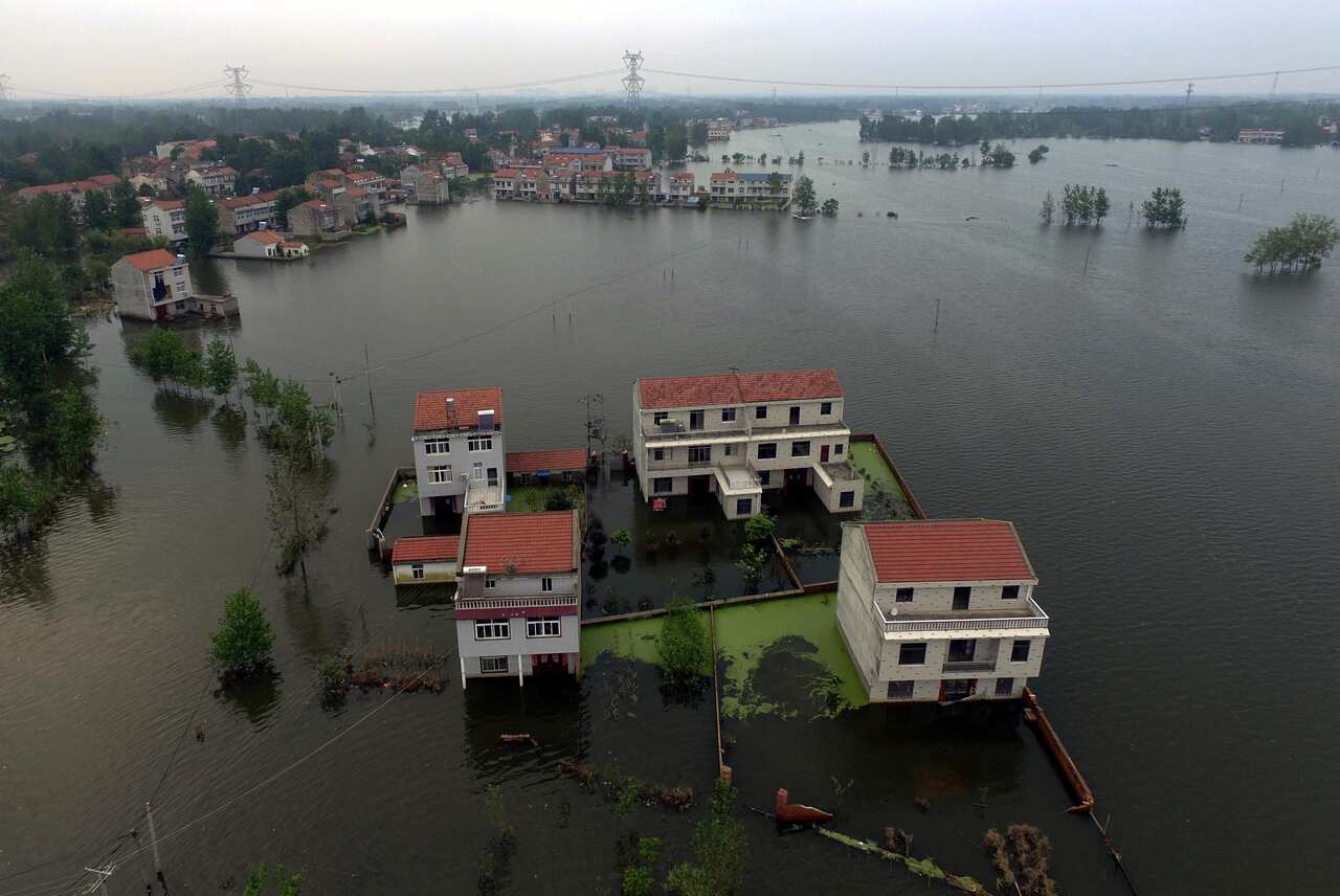 A picture made available on 23 July 2016 of an aerial view of waters flooding Xinhua Village of Xinchang county in Wuhan city.