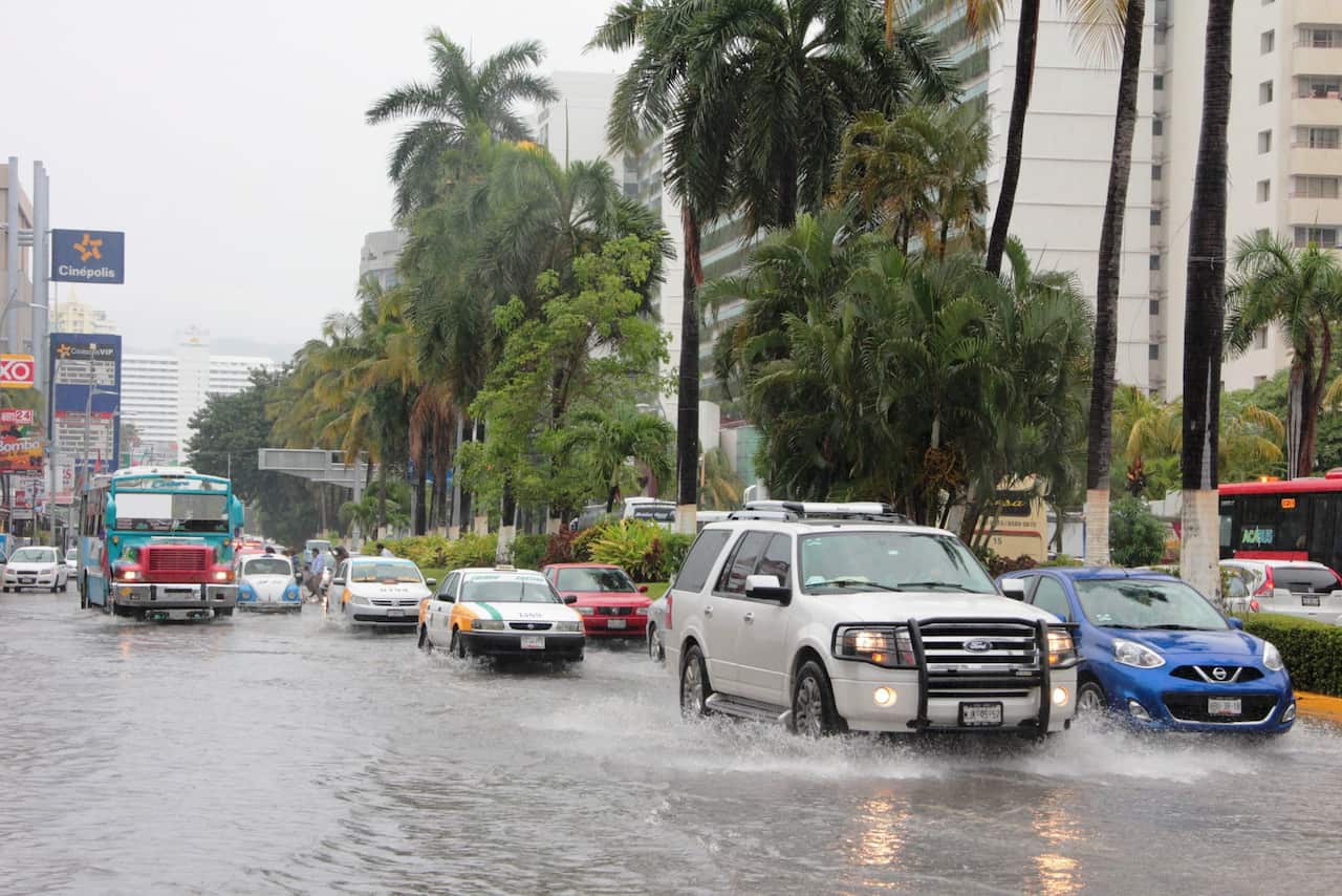 A general view shows vehicles transiting at a flooded street due to heavy rains left by Tropical Storm Earl's passage in Acapulco, Mexico, 06 August.