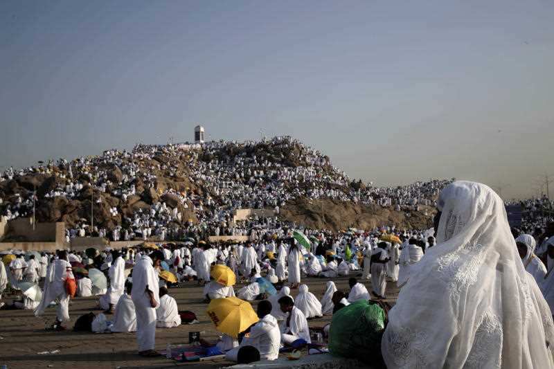 Muslim pilgrims pray on a rocky hill known as Mountain of Mercy, on the Plain of Arafat, during the annual hajj pilgrimage near the holy city of Mecca