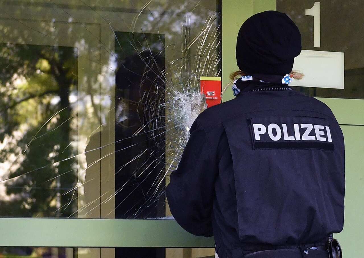 A police officer seals the damaged front door of a residential property in a housing estate in the Yorck area of Chemnitz, Germany, 09 October 2016.