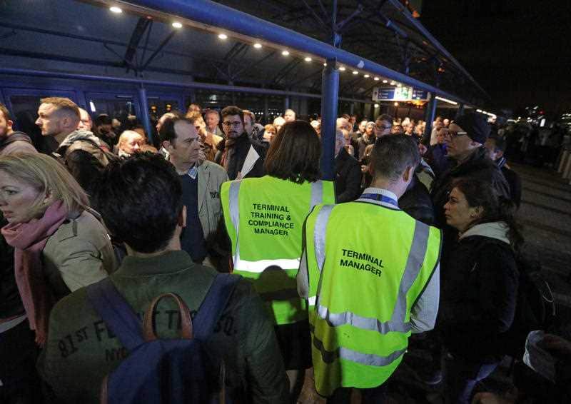 People queue outside London City Airport which has reopened after dozens of passengers were treated for breathing difficulties