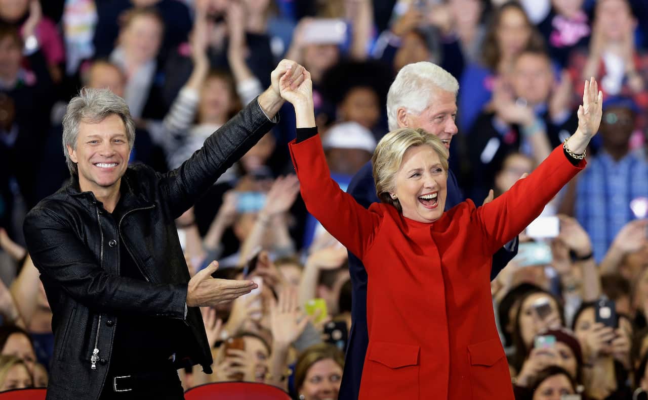Democratic presidential candidate Hillary Clinton is joined by Jon Bon Jovi, left, and former President Bill Clinton during a campaign rally in 2016.